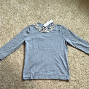 Blue Calvin Klein sweater with white pearl button embellishes on collar.
